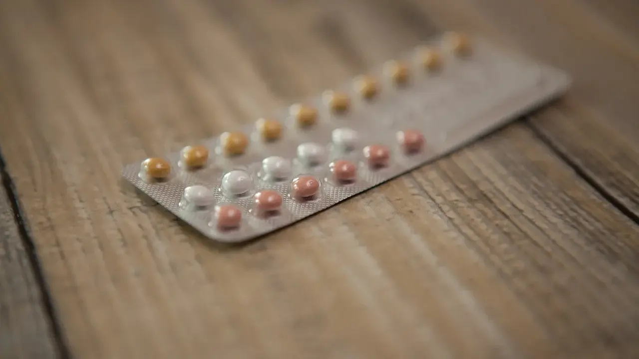 Blister opakowania tabletek antykoncepcyjnych na drewnianym tle. Zastanawiasz się nad tabletki antykoncepcyjne skutki uboczne?
